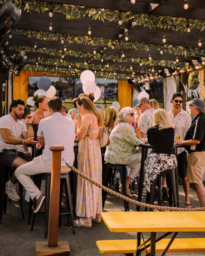 people enjoying 314 beer garden -- burgers and sandwiches, sales and sides, wood-fire oven, indoor and outdoor seating, with live entertainment 